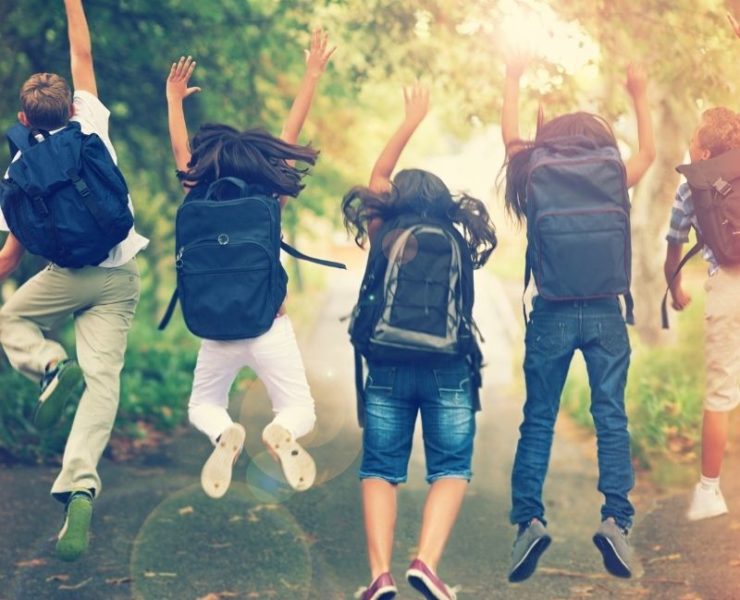 excited students with backpacks