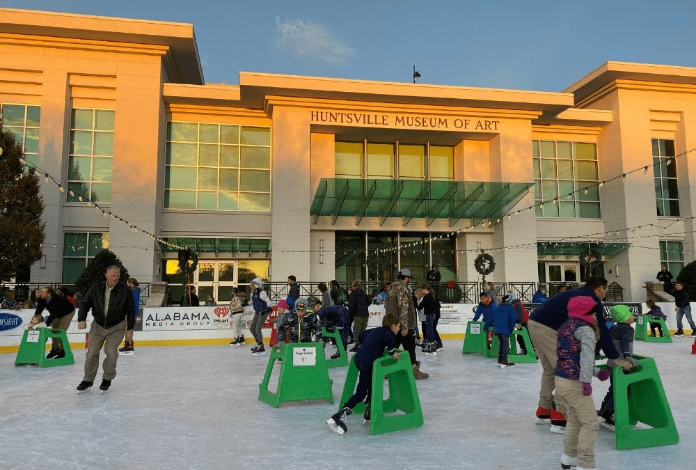 people ice skating in front of the Huntsville Museum of Art