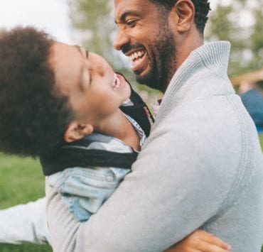 dad playing with son outside