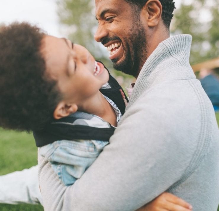 dad playing with son outside