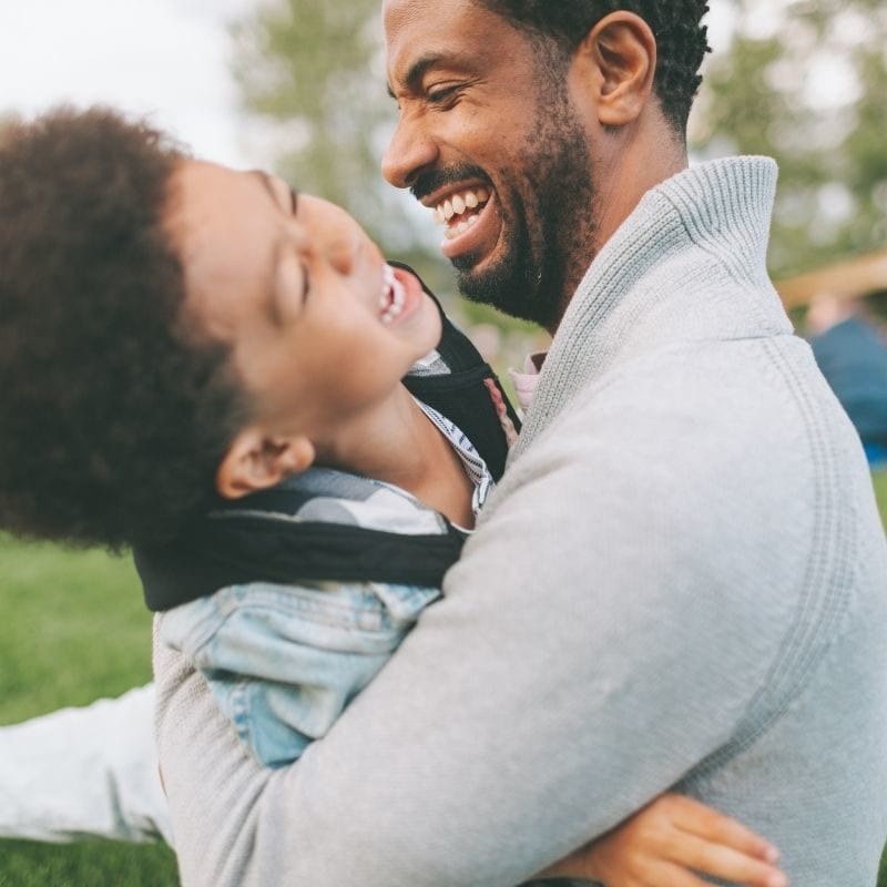 dad playing with son outside
