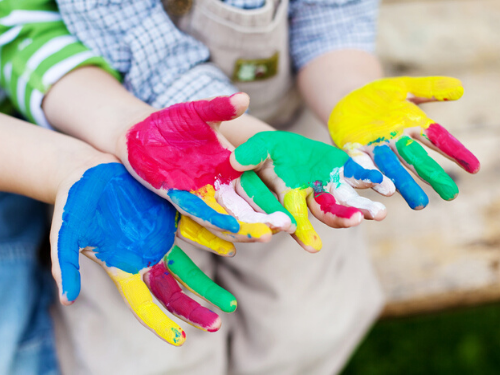 children's hands covered in fingerpaint