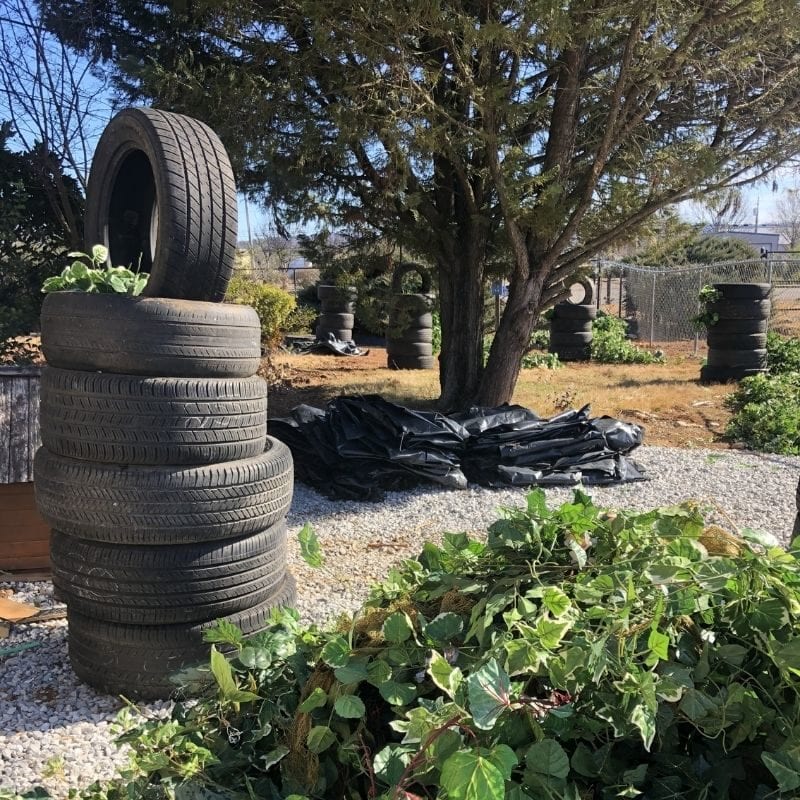 An outdoor Nerd arena at Rage Room includes shelter made from tires and natural landscaping.