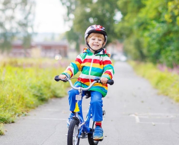 boy riding his bike on paved path