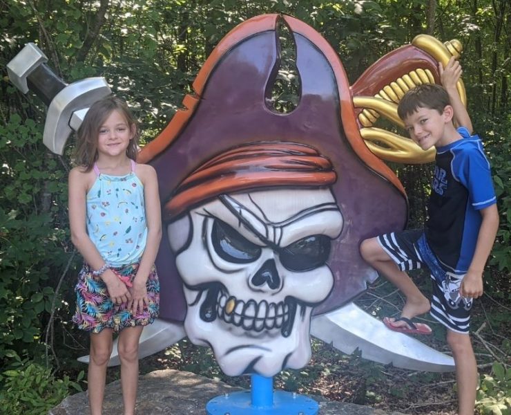 A pirate skull in front of two cross swords mark the entrance to Pirate's Bay waterpark in Leesburg.