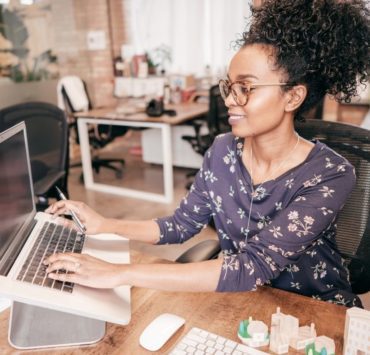 woman sititng at a computer working on taxes