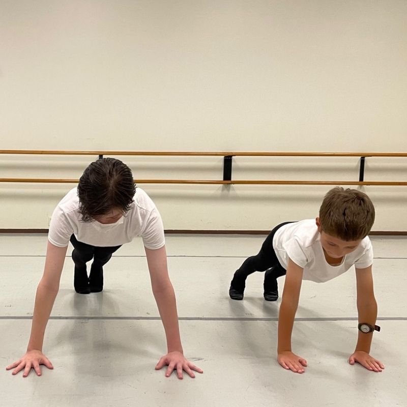 young boys doing pushups in ballet class