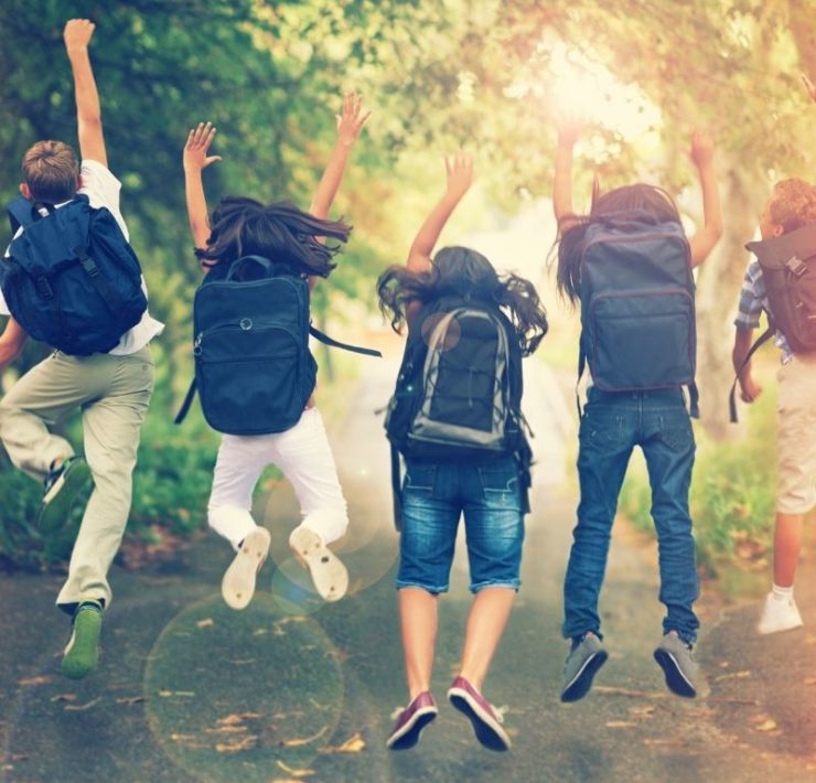 excited students with backpacks