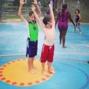 two boys playing in the fountain at the Everybody Can Play Splashpad in Huntsville
