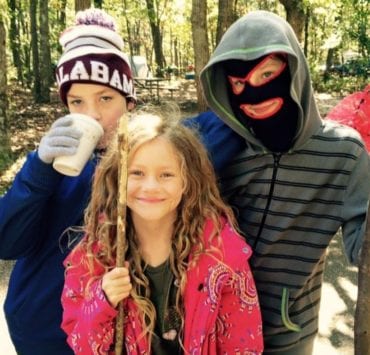 three lids smiling while camping at Monte Sano state park in huntsville