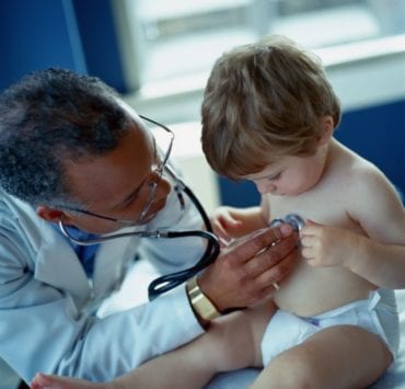 young boy being examined by pediatrician