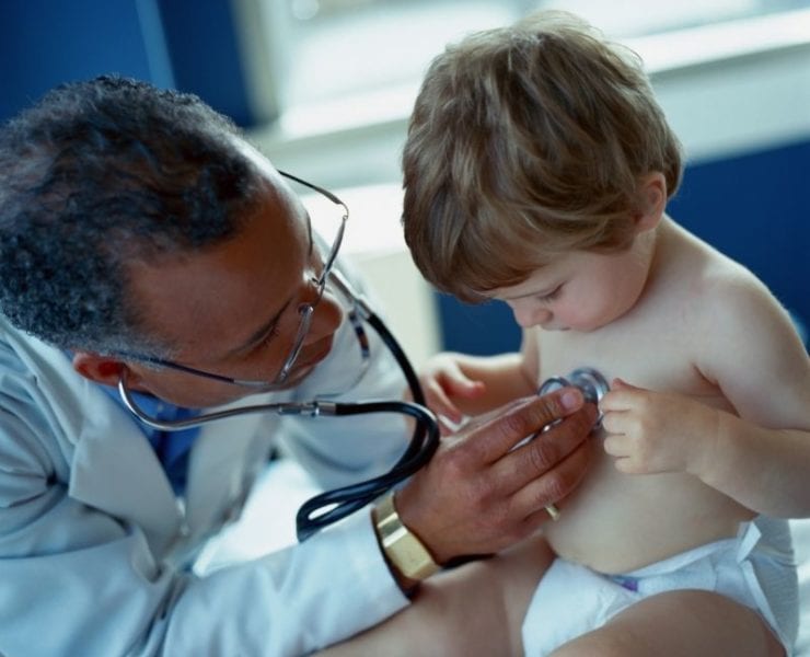 young boy being examined by pediatrician