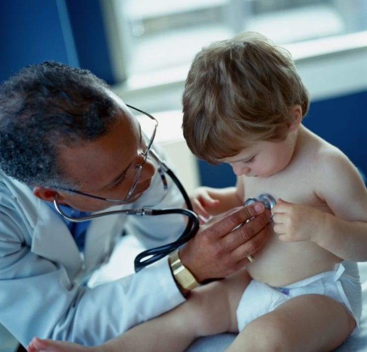 young boy being examined by pediatrician