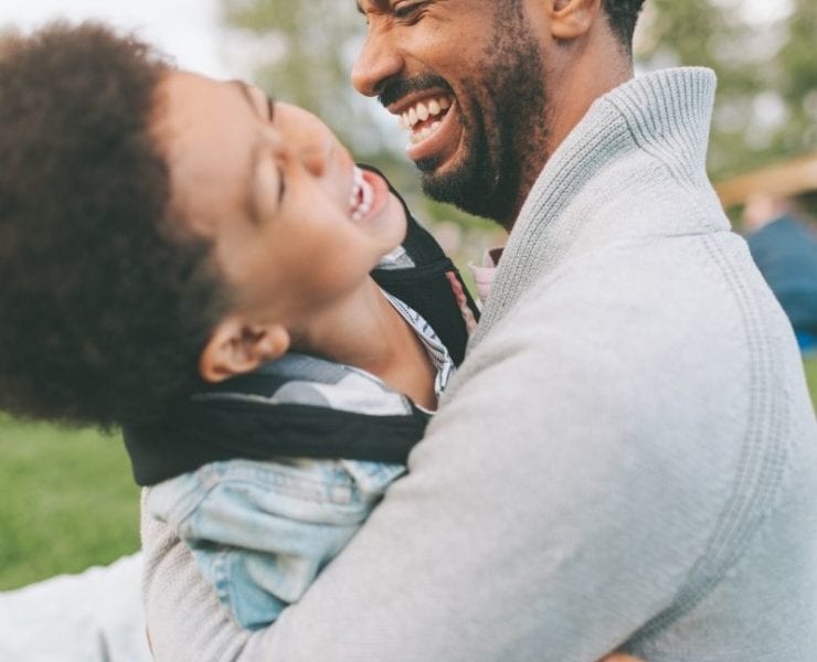 dad playing with son outside