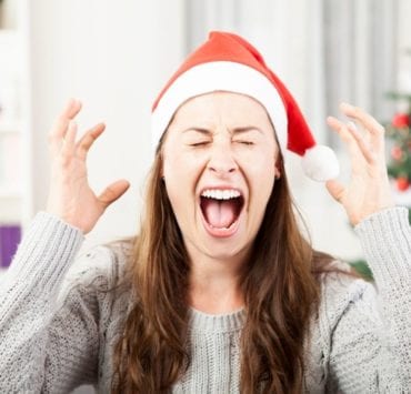 woman screaming in front of a christmas tree
