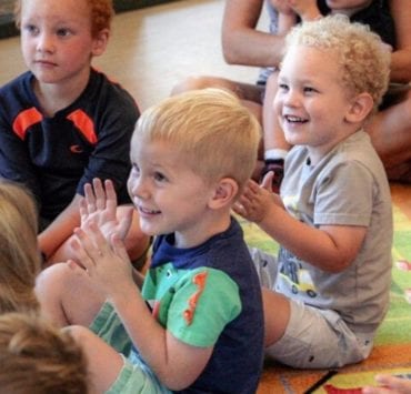 children sitting on a rug at story time in the Madison Library