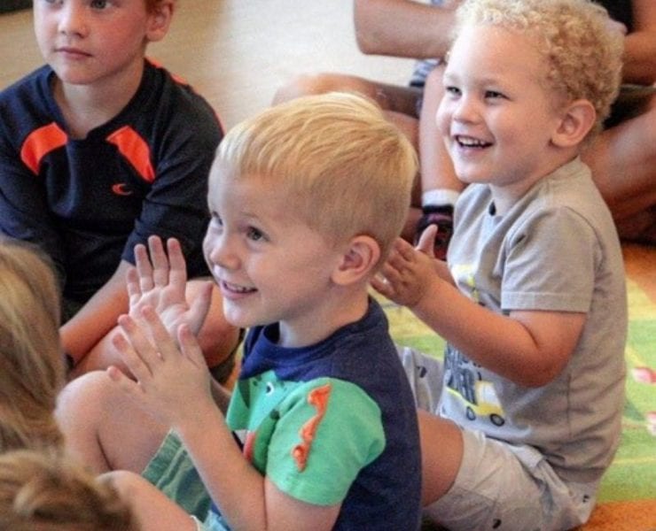 children sitting on a rug at story time in the Madison Library