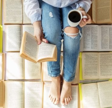woman reading book and drinking tea