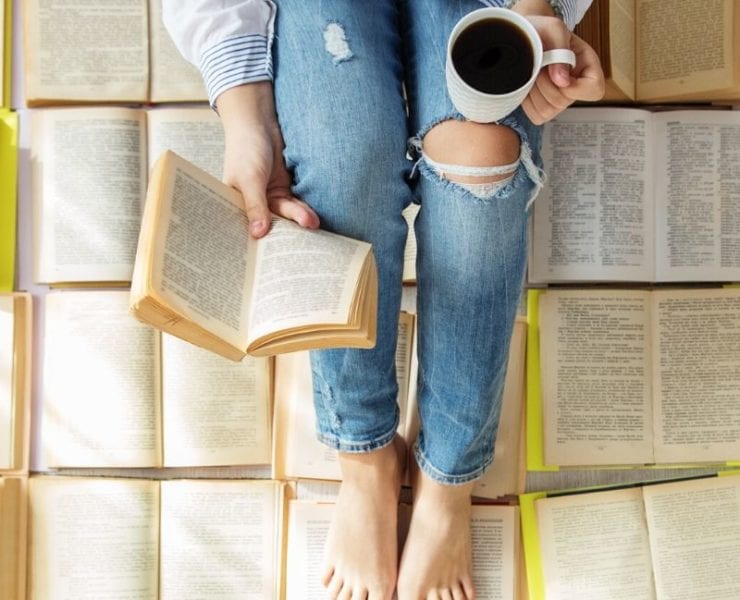 woman reading book and drinking tea