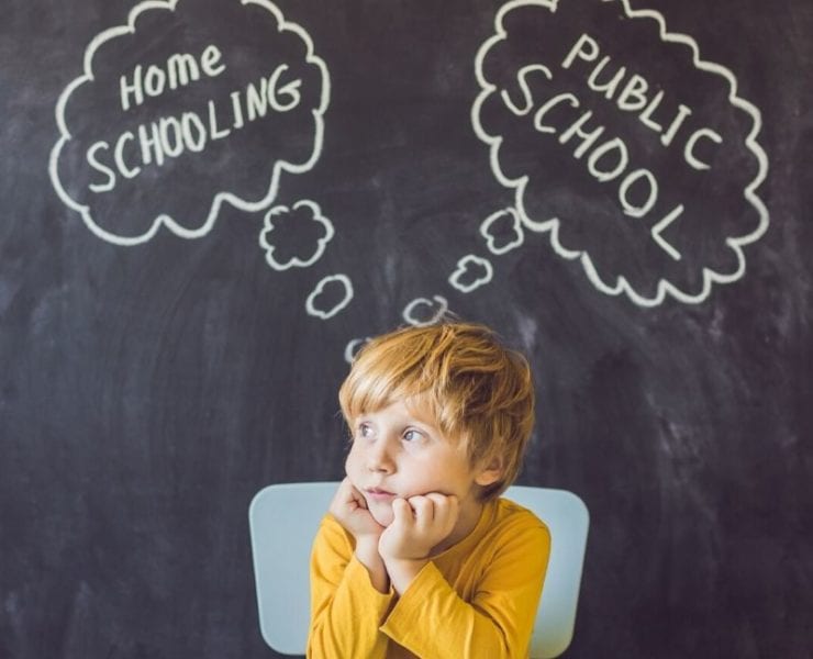 boy sitting at desk thinking about homeschool or public school