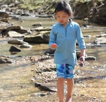 yonder girl wading in a creek