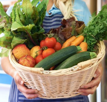 A basket full of fruits and vegetables displays what can be expected from a CSA.