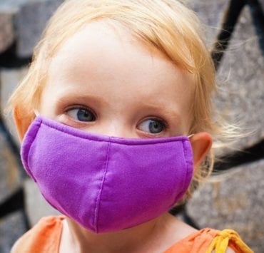 young girl wearing mask