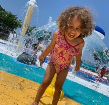 little girl playing in the water at the SNAP Playground Splashpad Hartselle AL