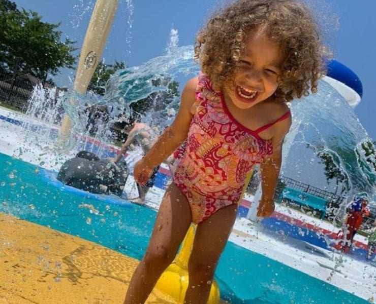 little girl playing in the water at the SNAP Playground Splashpad Hartselle AL