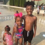 three children at the Showers Center splash pad