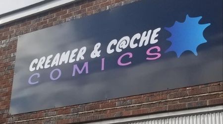 Exterior building sign for Creamer & Cache Comics in Huntsville Alabama
