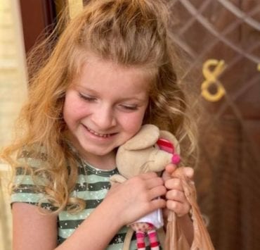 girl hugging a stuffed animal