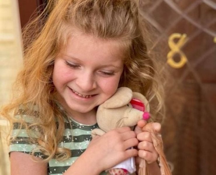 girl hugging a stuffed animal