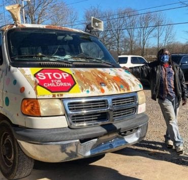 Mr. Bontu, the neighborhood's favorite ice cream man, stands beside his van that's in need of some repairs.