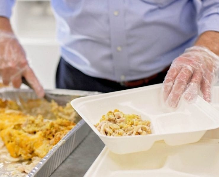 ©Moonbelle Photography A volunteer serves a hot meal at First Stop to help serve the homeless population in Huntsville.