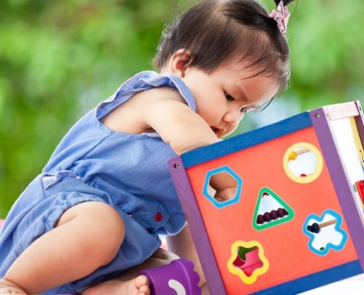 A child playing with a toy is a sample photo of what we're looking for in the Kids of the Week series.