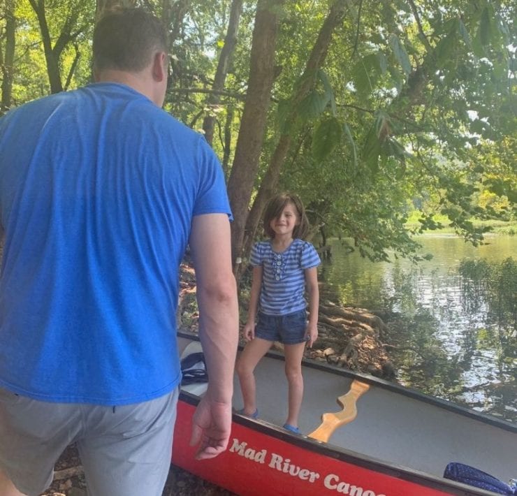 A father and daughter prepare to launch their NACK canoe onto Flint River.