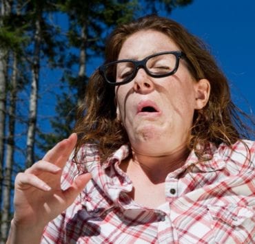 woman sneezing from pollen