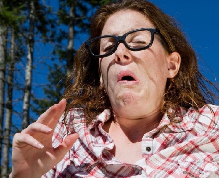 woman sneezing from pollen