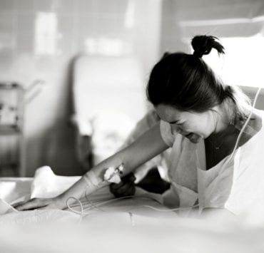 black and white photo of pregnant woman in the hospital