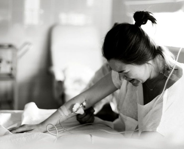 black and white photo of pregnant woman in the hospital