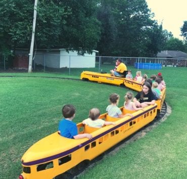 children riding a miniature train at the Athens Kiddie Carnival