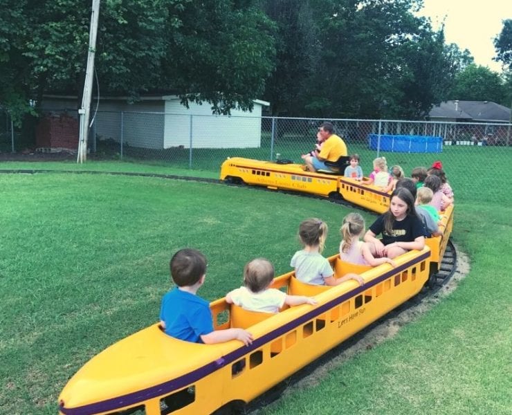 children riding a miniature train at the Athens Kiddie Carnival
