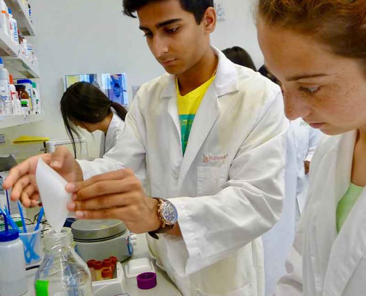 three teen students working in a lab at HudsonAlpha in Huntsville, Alabama