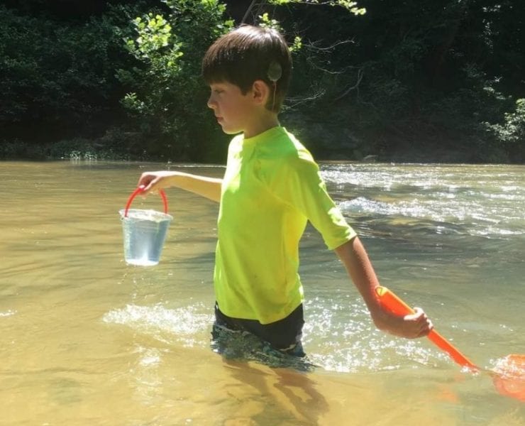 boy wading in an Alabama creek