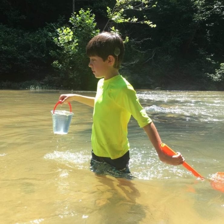 boy wading in an Alabama creek