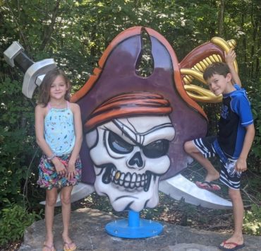 A pirate skull in front of two cross swords mark the entrance to Pirate's Bay waterpark in Leesburg.