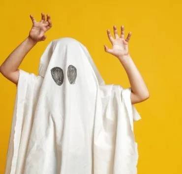 child in a ghost costume
