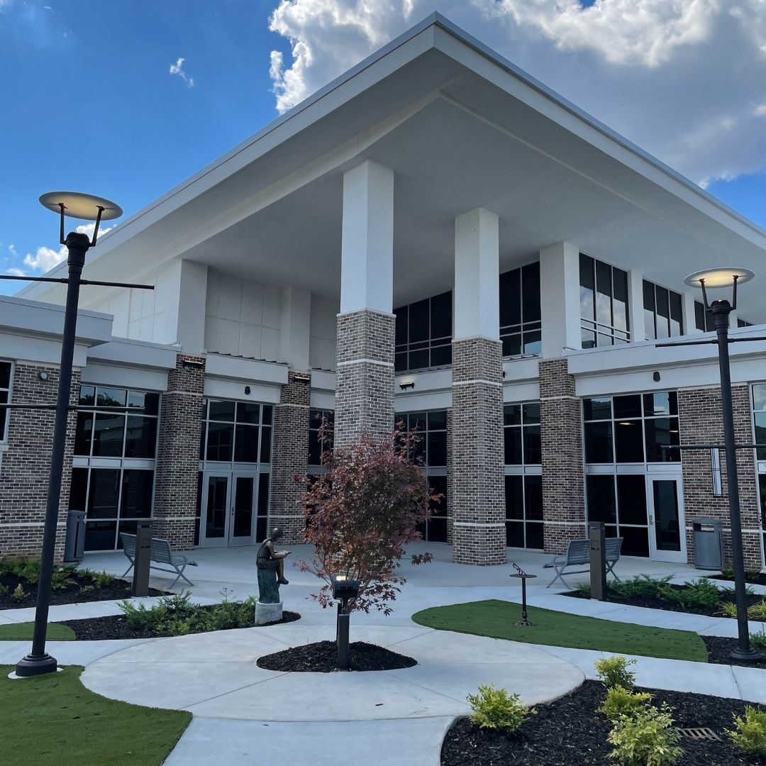 A gorgeous outdoor children's garden features lamp posts and various plants at the South Huntsville Library.