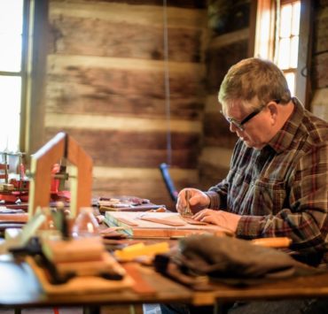 A man meticulously demonstrates his traditional trade at the Round Top Folk Festival.